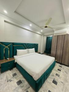a bedroom with a large bed in a room at Emerald Inn in Islamabad