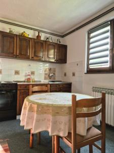 a kitchen with a table and a table and chairs at Rooms-Zejnep SARAJEVO in Sarajevo