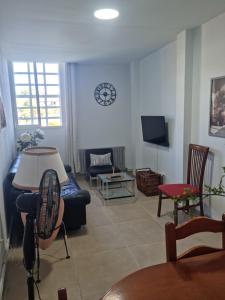 a living room with a couch and a tv at Casa rias baixas in Poio