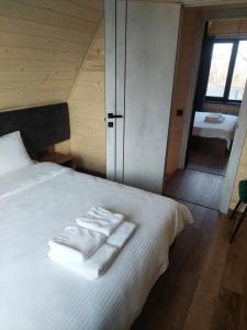 a bedroom with a bed with white towels on it at zatyshnyy dvoryk Затишний Дворик in Kolomiya