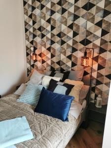 a bedroom with a bed with pillows on it at Apartament Kamil Kalisz in Kalisz