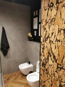 a bathroom with a white toilet and a sink at Apartament Kamil Kalisz in Kalisz +6 photos