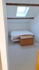 a small bedroom with a bed and a skylight at La maison COP&CO in Murat-sur-Vèbre
