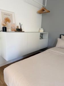 a white cabinet in a bedroom with a bed at Luxury Apartment Vorstetten Modern Zentral in Vörstetten