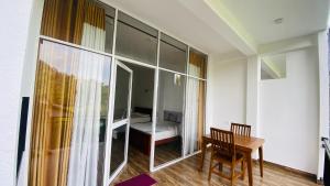 a room with a table and a room with a bedroom at 97 Ella in Ella
