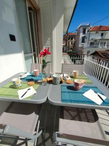 a table on a balcony with a meal on it at La Casa dello Zio Pollo in Dogliani