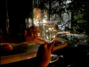 a person holding up a glass of beer at Hut on The Grove in Twizel