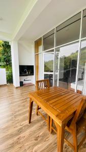 a wooden table and chairs in a living room at 97 Ella in Ella
