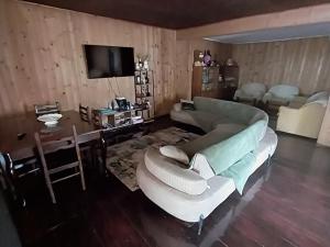 a living room with a couch and a table at Guesthouse Leno in Tsaldashi