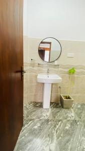 a bathroom with a sink and a mirror at 97 Ella in Ella