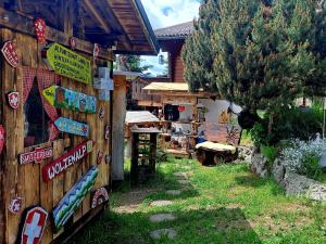 a store with signs on the side of a wooden fence at Alp Chnorz Penthouse in Nesslau