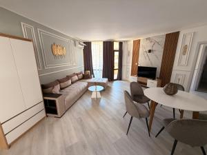 a living room with a couch and a table at Complex Sands Holiday Apartments in Sunny Beach