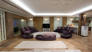 a large living room with couches and a tv at شالية 280 in Dammam