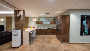 a kitchen and living room with a couch and a clock at شالية 280 in Dammam