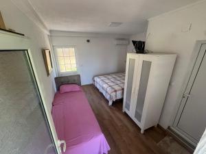 a small room with a bed and a small bedroom at Apartmani Konak in Star Dojran +2 photos