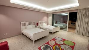 a bedroom with two beds and a living room at شالية 280 in Dammam +19 photos