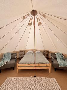 a bedroom with a bed in a tent at Anniksson Glamping Telk- Loodustelk in Virtsu