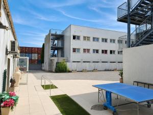 a blue ping pong table in front of a building at Campus Arkenciel - Montpellier Est in Mudaison