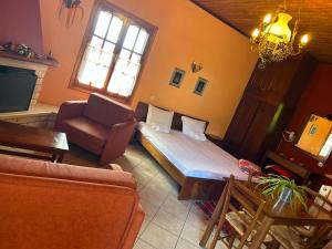 a living room with a bed and a couch at Epavlis Elena in Konitsa