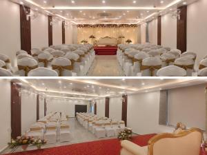 a banquet hall with rows of chairs and a stage at Hotel Royal Ashoka in Rājgīr