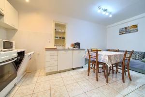 a kitchen and dining room with a table and chairs at Kuca za odmor Kornic in Kornić +25 photos