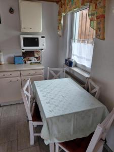 a small kitchen with a table and a window at Ferienwohnung Jahner in Reinhardtsdorf
