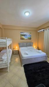 a bedroom with two bunk beds and a bed sidx sidx sidx at Villa Alvara in Vlorë