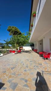 a shadow of a person taking a picture of a building at Villa Alvara in Vlorë