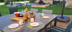 a picnic table with food and drinks on it at La Belle Bourguignonne in Crêches-sur-Saône