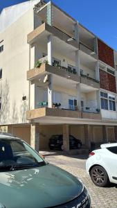 a building with cars parked in front of it at Vila apartment, free parking in Cascais