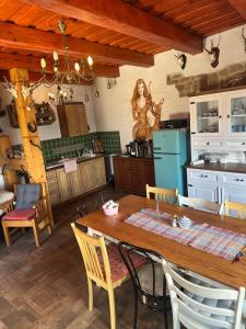 a kitchen with a wooden table and chairs at Privát Migáč in Vrbov
