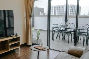 a living room with a couch and a table and chairs at Sky villas with large balcony in Hanoi
