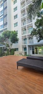 a bench sitting in front of a building at The Trust Huahin By Sopida in Hua Hin
