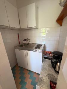 a small kitchen with a sink and a stove at Studio Apartmani ISRA in Palit +29 photos