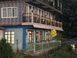 a house with a balcony on top of it at The Dusk Stay in Sonāda
