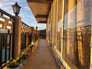 a balcony with potted plants on a building at The Dusk Stay in Sonāda