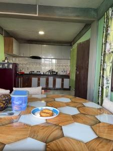a kitchen with a table with a plate of food on it at The Dusk Stay in Sonāda