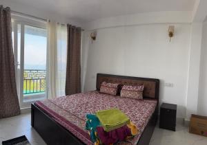 a bedroom with a bed with a view of the ocean at The Dusk Stay in Sonāda +9 photos