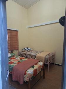 a room with two beds in a room at Jeda Salihah in Baling