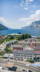 an aerial view of a city and the water at Hotel Aurora & Appartamenti in Nago-Torbole