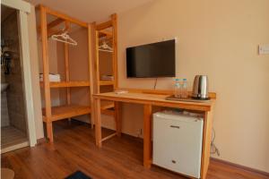 a room with a desk with a computer and a television at Zuma Hotel Cyprus - Turkish Side in Nicosia