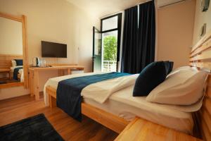 a bedroom with a large bed and a window at Zuma Hotel Cyprus - Turkish Side in Nicosia