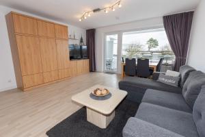 a living room with a couch and a table at Hanseatic 110 in Duhnen