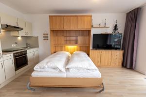 a bedroom with a bed with white pillows on it at Hanseatic 110 in Duhnen