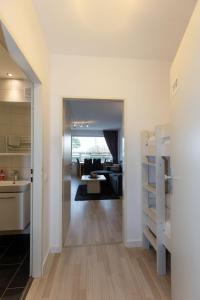 a room with a kitchen and a living room at Hanseatic 110 in Duhnen +12 photos