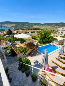 a view of a swimming pool and a resort at Al Mare Vacation Home in Igalo