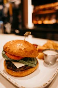 a hamburger on a plate on a table at Courtyard by Marriott Owatonna Downtown in Owatonna