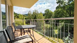 a patio with a table and chairs on a balcony at Apartament Bukovy Wisła in Wisła