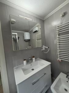 a bathroom with a white sink and a mirror at Apartman DIN in Travnik +14 photos