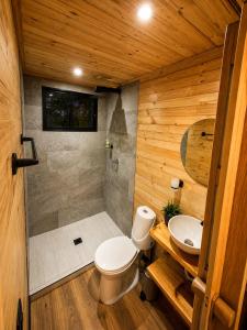 a bathroom with a shower and a toilet and a sink at Basecamp Colombia in Carmen de Carupa +32 photos